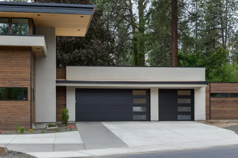 Stunning Mid Century black garage doors with frosted glass panels in Bala Cynwyd, PA, enhancing the modern home’s design.